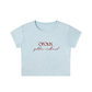 A light blue short-sleeve crop top t-shirt with 'oroux golden redhead' printed in red on the chest, shown against a plain white background.