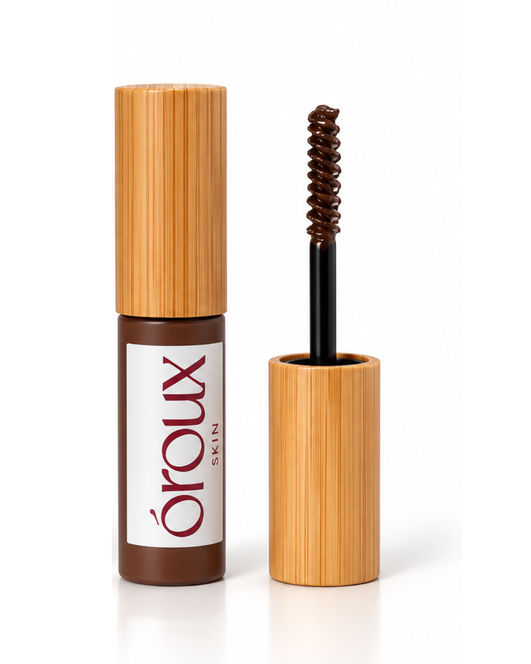 A dark auburn brow gel bottle with a bamboo-textured cap stands next to its open wand applicator, which shows the brown product loaded into the spoolie, on a white background.