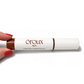 A hand with red painted nails holds a white tube of Éroux Skin Long & Rixou Peptide Mascara against a plain white background.