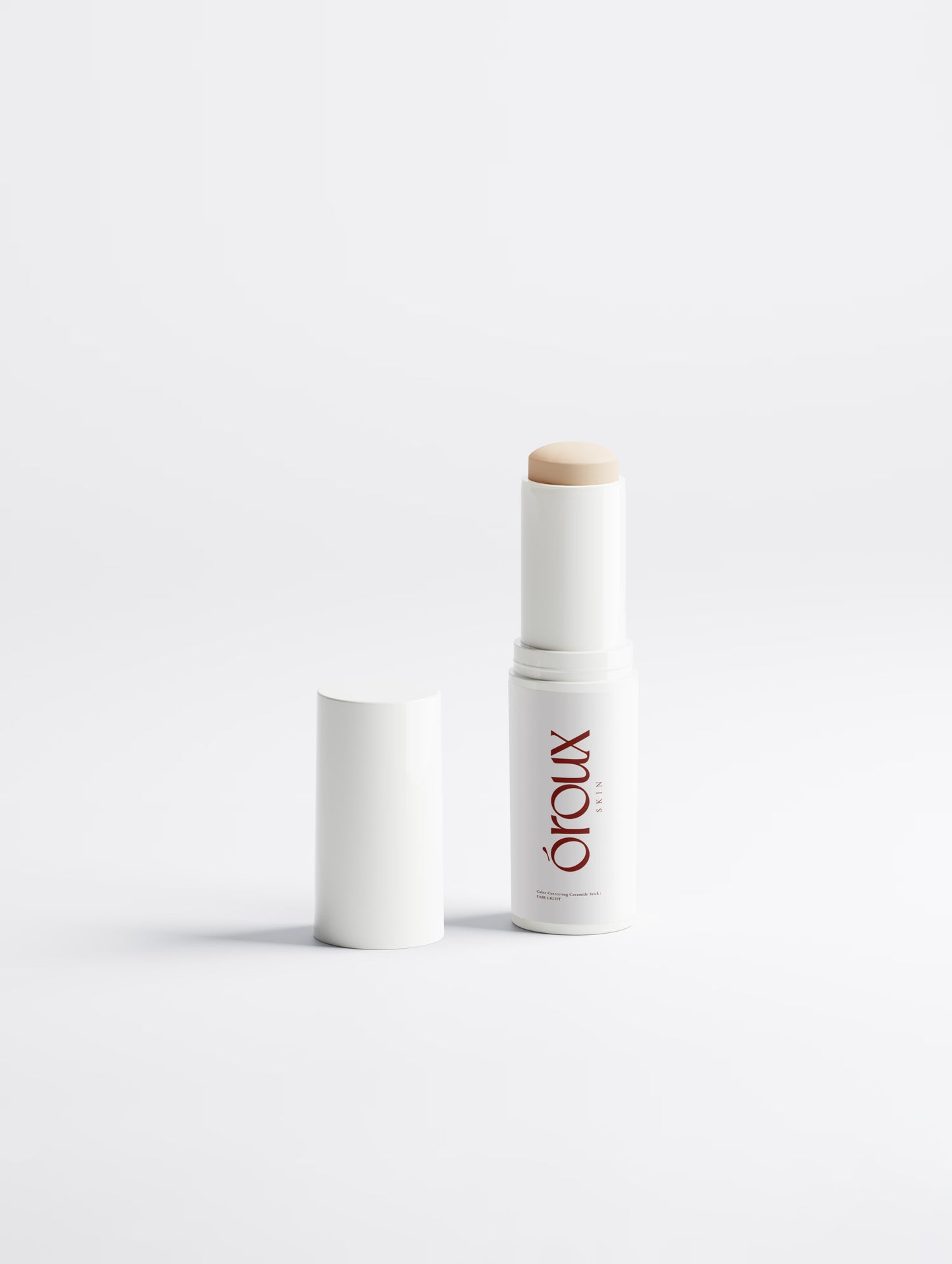 A white cosmetic stick container with its cap removed, showing a light beige product stick and the red 'orlux' brand name, on a clean white background.