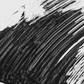 A close-up of a thick black mascara brush stroke with visible texture and horizontal ridges on a white background.
