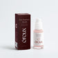 A bottle of oroux Cica Sensitive Skin Serum with a white pump and clear cap, next to its dark brown box, on a light gray background.