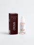 A bottle of oroux Cica Sensitive Skin Serum with a white pump and clear cap, next to its dark brown box, on a light gray background.