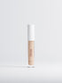 Cosmetic concealer bottle with white cap on a light gray background