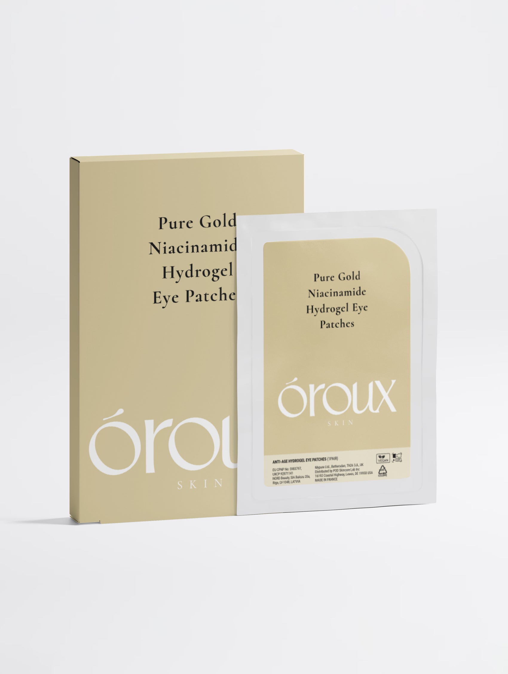A beige and white box of öroux Pure Gold Niacinamide Hydrogel Eye Patches shown next to an individual packet of the eye patches on a clean white background.