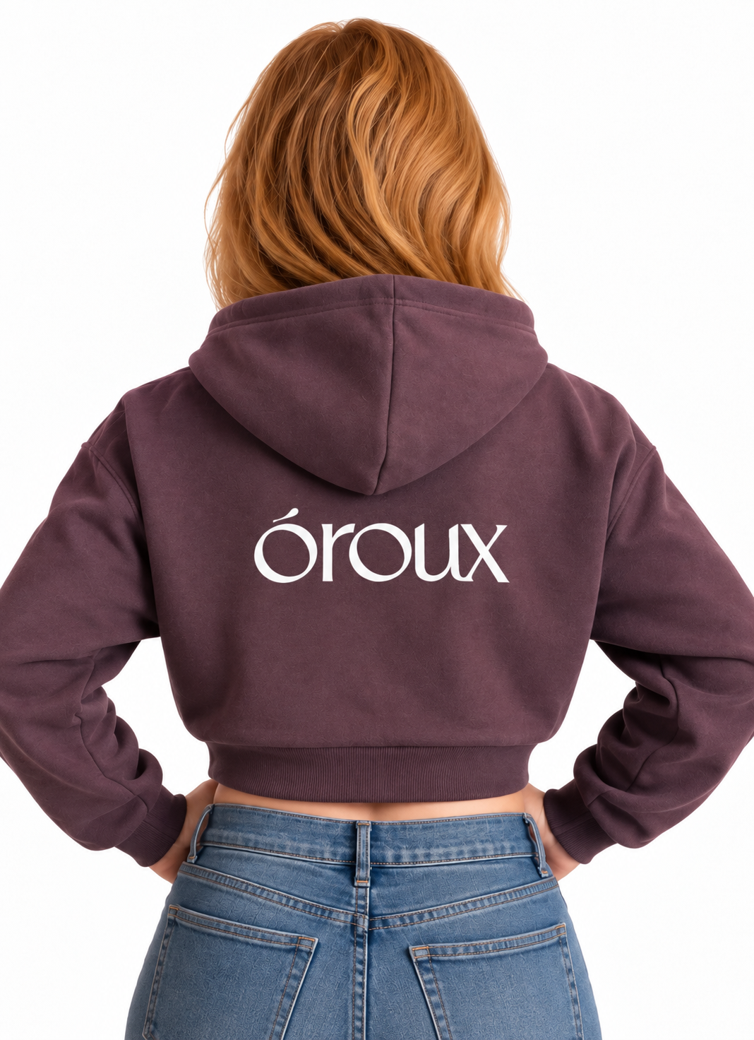 A woman viewed from behind wearing a dark plum purple cropped hoodie with the word 'óroux' printed in white across the back, paired with blue jeans against a plain white background.