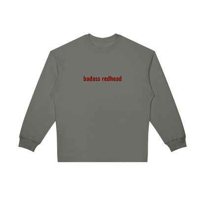 Close-up of embroidered 'Badass Redhead' text on crewneck sweatshirt