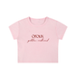 A light pink short-sleeve crop top t-shirt with 'oroux golden redhead' printed in dark red text on the chest, shown against a plain white background.