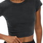 Person wearing a dark gray crop top on a white background