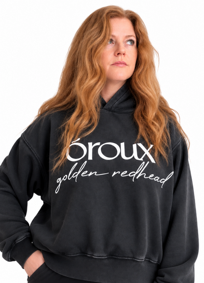 A side-by-side comparison of a model wearing a faded black hoodie with white text that reads 'oroux golden redhead'. The model has long, wavy golden-red hair.