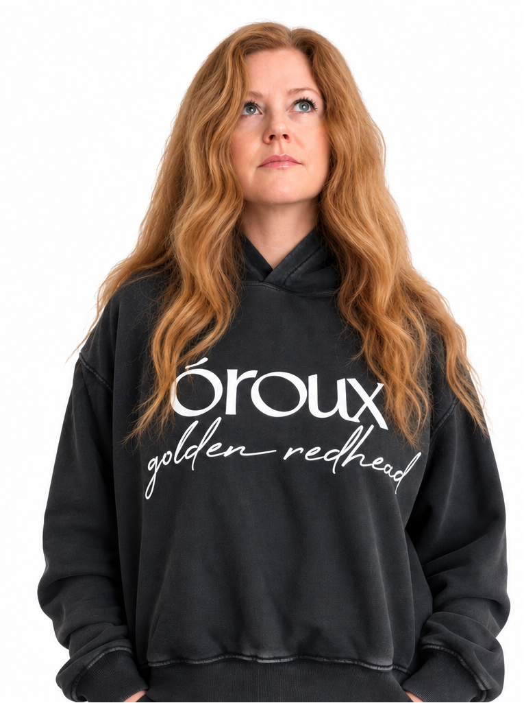 A side-by-side comparison of a model wearing a faded black hoodie with white text that reads 'oroux golden redhead'. The model has long, wavy golden-red hair.