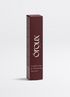 A tall, slim rectangular box of Óroux Skin Lengthening & Volumising Mascara in a deep burgundy color, standing upright on a light gray background.