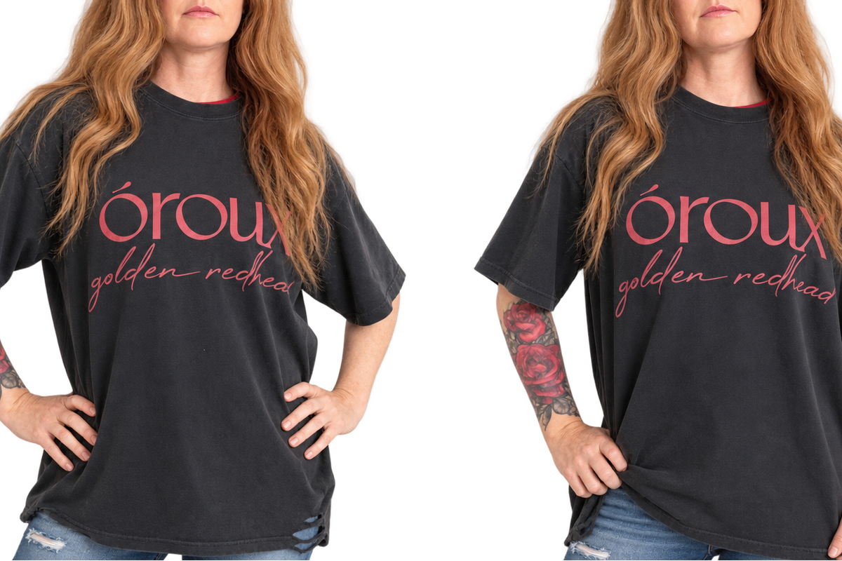 A side-by-side comparison of a woman wearing a black graphic t-shirt with pink text that reads 'oroux golden redhead'. The image shows the same model from the waist up, with the shirt displayed in two slightly different poses against a plain white background.